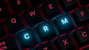 Keyboard with CRM keys lit up, representing choosing a home service CRM for a small business