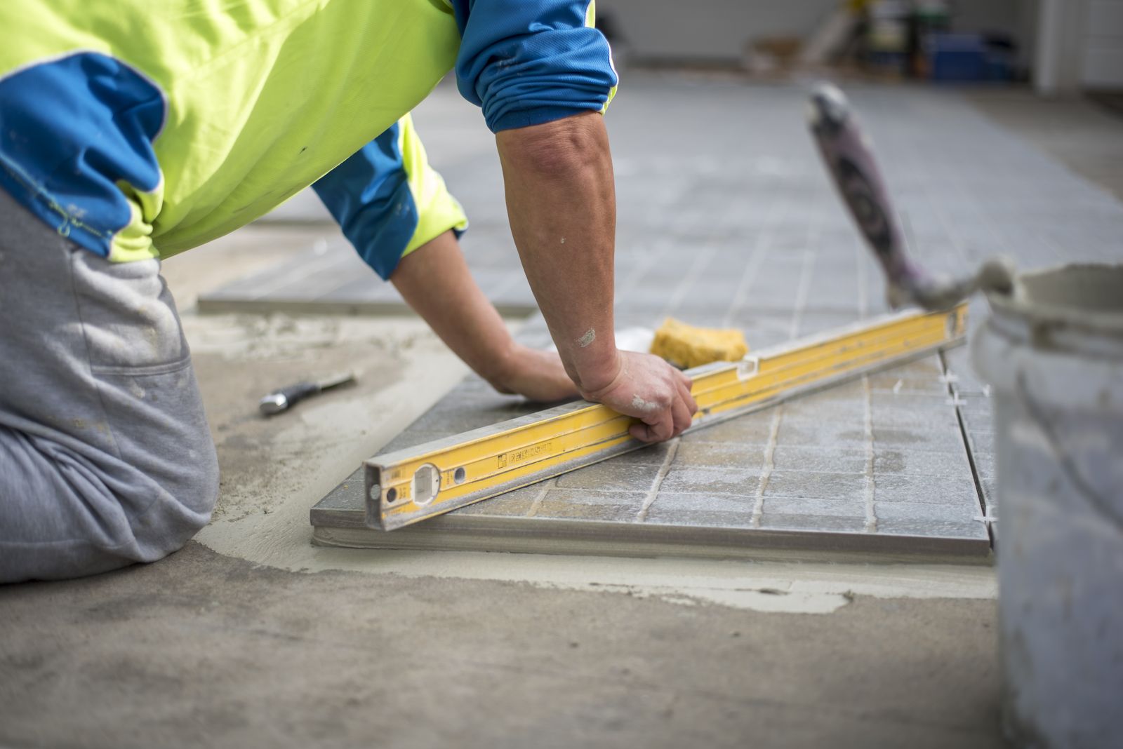 Contractor leveling new floor tile