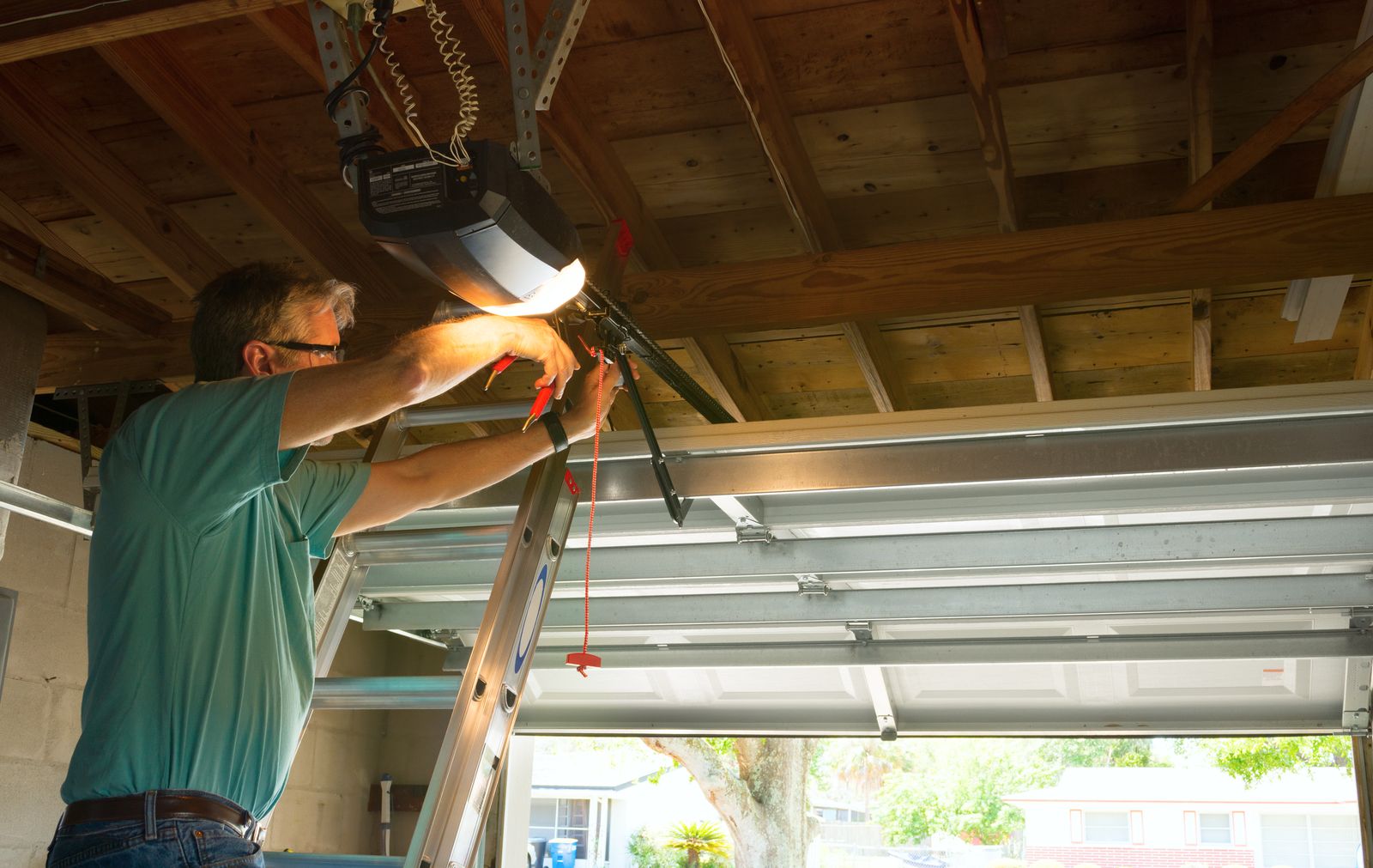 Garage door technician installing a garage door opener